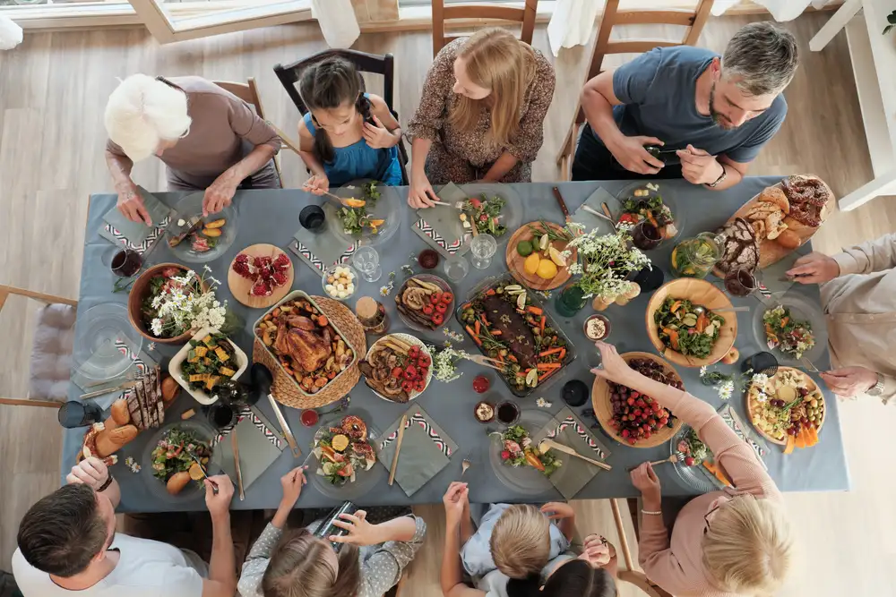When the number of guests calls for tables to be rearranged, a restaurant reservation system can help manage the flow of diners and optimize seating arrangements. This images shows a large family enjoying a celebration at a restaurant, with a table reserved for them through a restaurant reservation system.