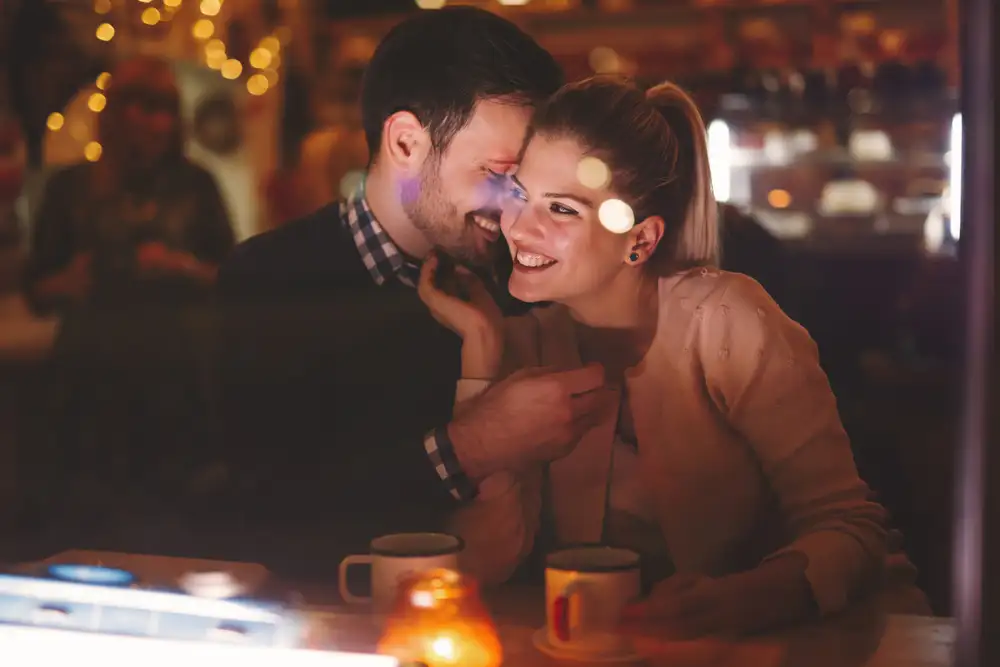 A restaurant reservation system is software that allows restaurants to take and manage table bookings digitally. This image shows a couple enjoying date night at a restaurant, with a table reserved for them through a restaurant reservation system.